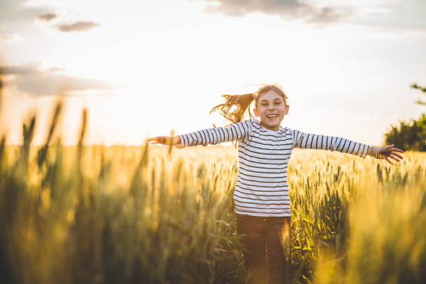 istock Little girl running cross the wheat field 807769574