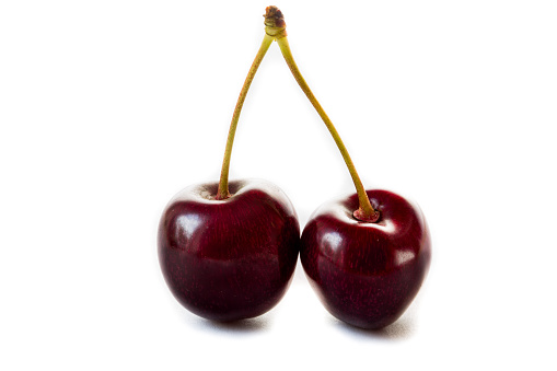 Two red cherries isolated