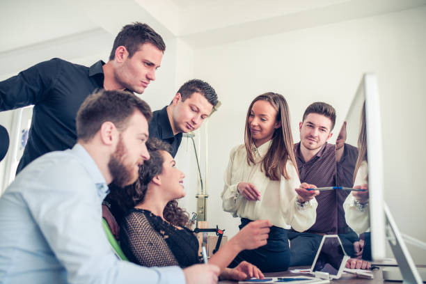 istock Group of Young Coworkers Working on Project in Modern Office 807783896
