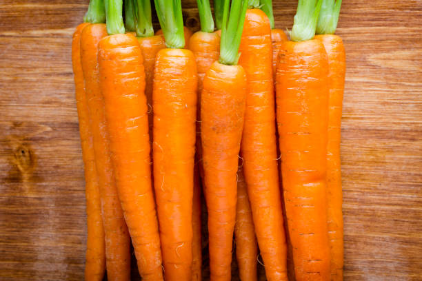 istock Fresh carrots on the wooden background. 807791606