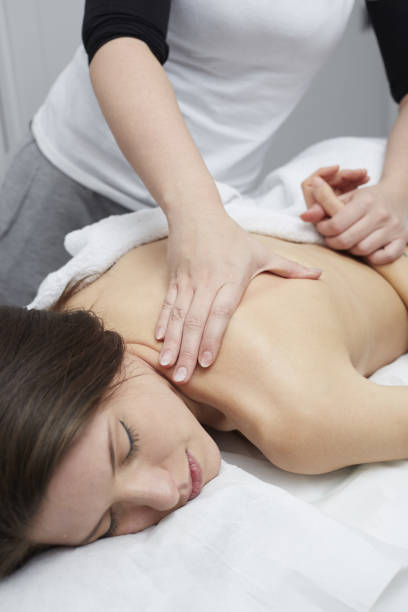 istock Beautiful woman having relaxing massage in spa salon 807796058