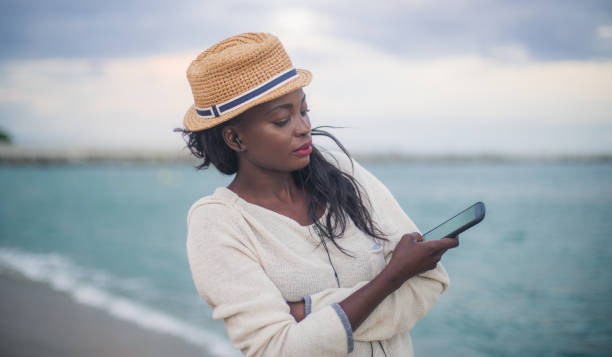 istock Woman standing on the beach 807814252