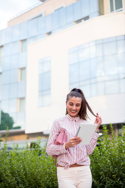 istock Beautiful brunette on the street with tablet 807819876