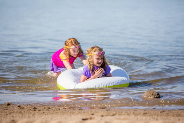 istock Two Girls Playing in Water At Beach 807822408