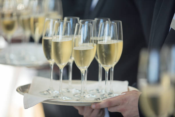 istock Waiters carrying champagne on tray 807827728