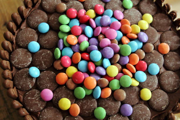 istock Chocolate cake covered in chocolate fingers, chocolate buttons and chocolate beans 807828126