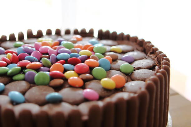 istock Chocolate cake covered in chocolate fingers, chocolate buttons and chocolate beans 807828448