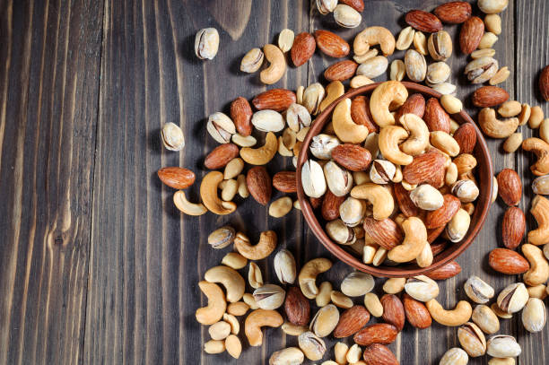 istock Mixed Nuts on dark background. Healthy food and snack. 807828544