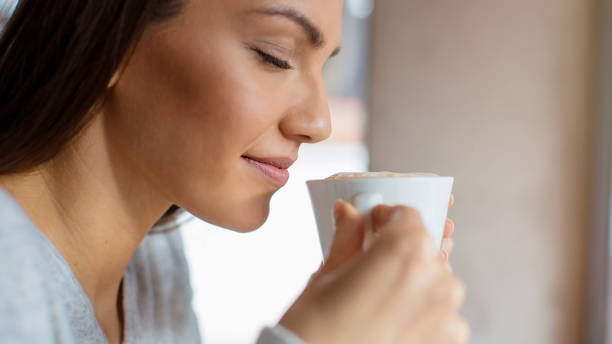 istock Beautiful young woman enjoying her morining coffee 807833916
