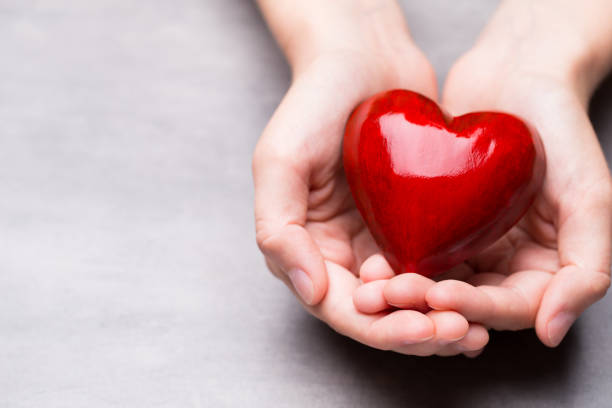 istock Red wood heart in child hands. 807836486