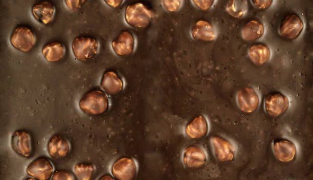 istock Chocolate background. Milk chocolate with hazelnuts close-up. 807844352