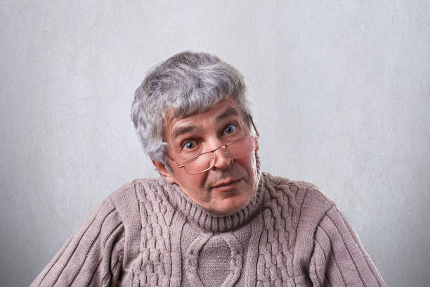 istock Senior, elderly man in glasses looking with wide open eyes having clever expression. A wise grandfather in glasses having surprised expression isolated over white background. People and emotions. 807844646
