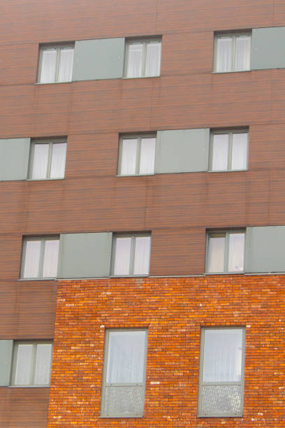 istock Gray windows on brick and modern walls. Old and new. Vertical. 807855676