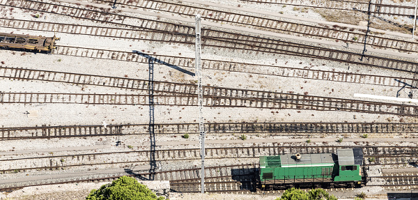 Green locomotive on railway at Port Vell in Barcelona, Spain.