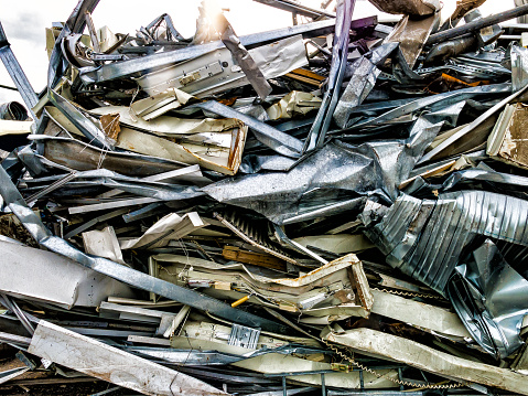 Scrap, metal and aluminium pressed together i a pile of metal junk