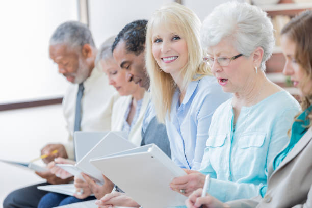 istock Confident woman smiles during retirement planning class 807900320
