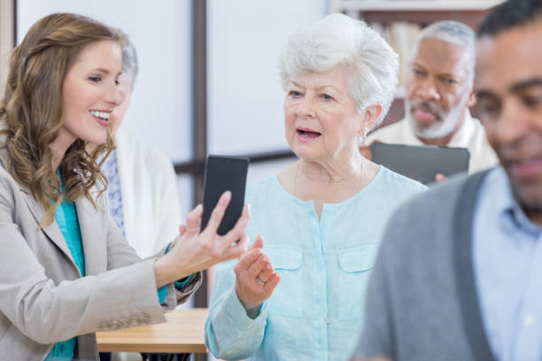 istock Interested senior woman learns to use smart phone 807900896