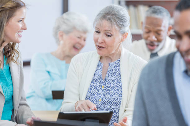 istock Senior woman learns to use digital tablet 807900952