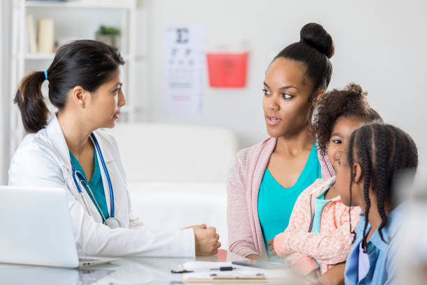 istock Concerned single mom talks with daughters' pediatrician 807902442