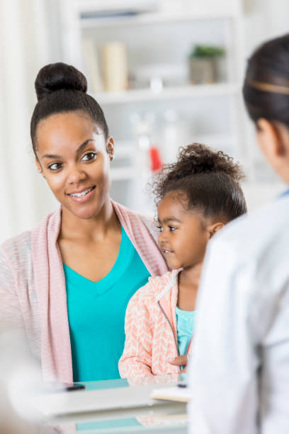 istock Confident young mother talks with her child's doctor 807902450