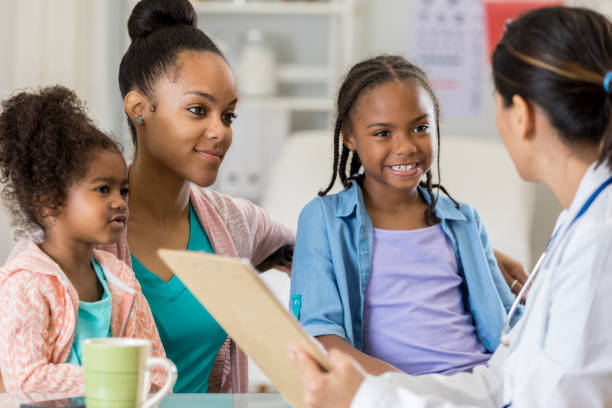 istock African American mom talks with her daughter's doctor 807902804