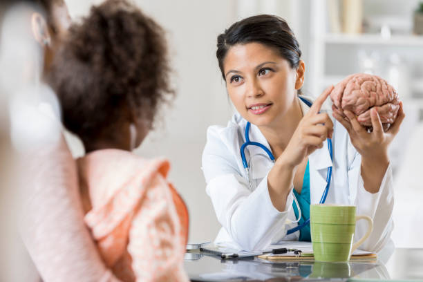 istock Pediatric neurologist talks with young patient's mom 807903032