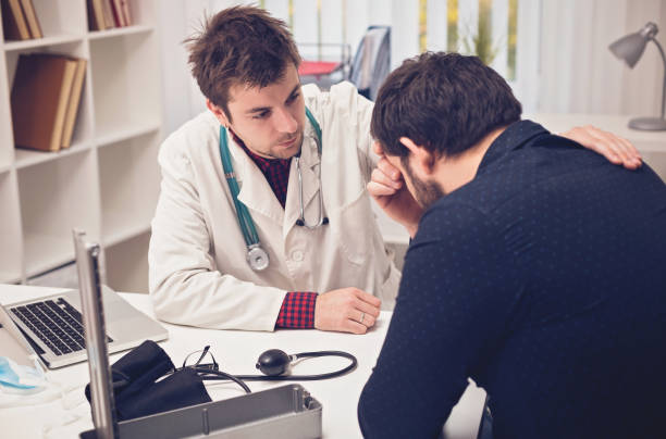 istock young doctor consoles his patient 807904532