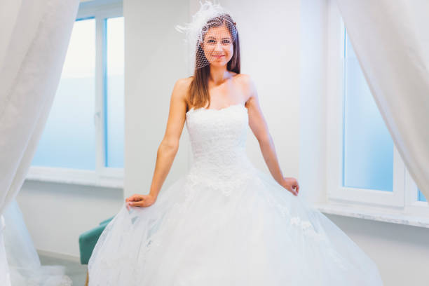 istock Fashion model posing in white dress 807909478