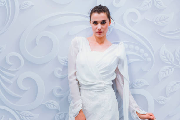 istock Fashion model posing in white dress 807920700