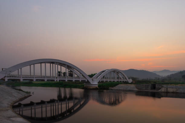 istock The white bridge backdrop orange sky at the morning in Lamphun. Thailand 807966176