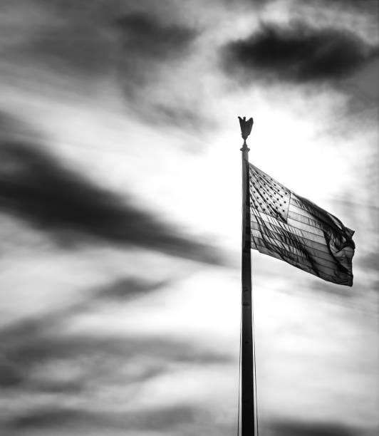 istock American Flag in front of Sun Setting 807984030