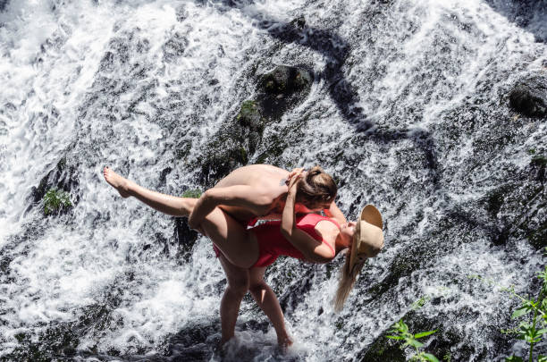 istock sexy playfull couple play in water 807986158