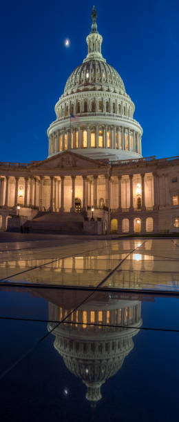 istock Moon Over the US Capitol Building Reflecting on Glass Surface 807986286