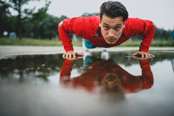 istock Young athletic man exercising after rainy day 807986898