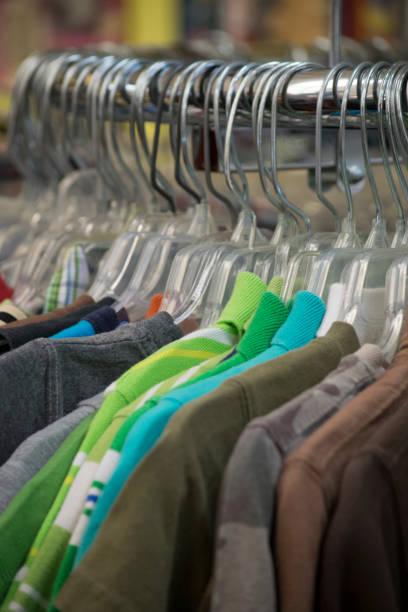 istock Clothing hanging on a rack in a store 807989480