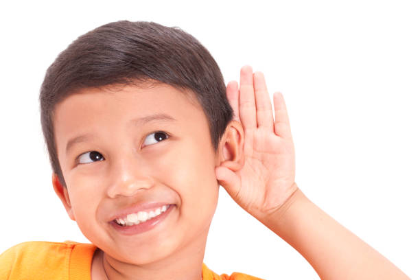 Portrait of Asian boy clenching fists, Ready to fight gesture. Kid in boxing stance looking straight at camera isolated on white background.