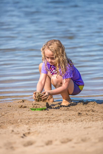 istock Girl Playing in Sand At Beach 808006852