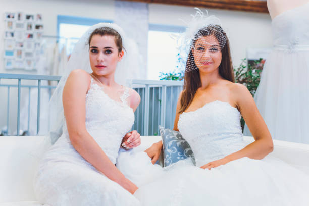 istock Two friends trying on wedding dresses 808012312