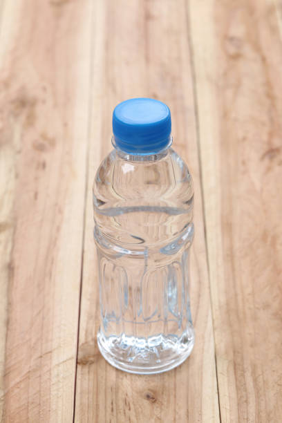 istock Plastic of Water bottles on wooden floor. 808012404