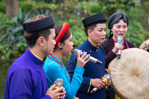 Hanoi, Vietnam - Feb 9, 2017: Folk singers singing Bac Ninh duets, folk singing on the boat in La Phu village, Hoai Duc. Intangible Heritage of Humanity.