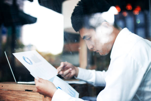 istock young asian man holds business report 808053154