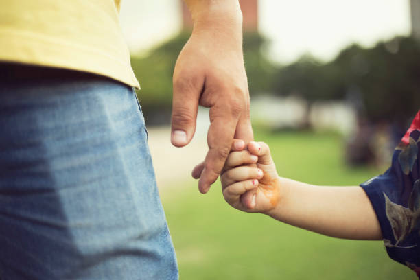 istock Father holding little girl's hand 808067202