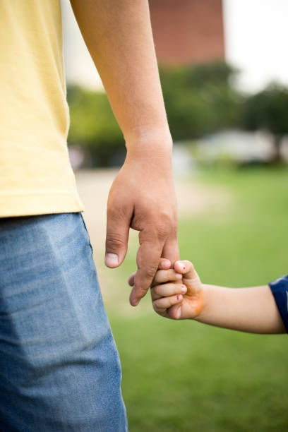 istock Father holding little girl's hand 808067240