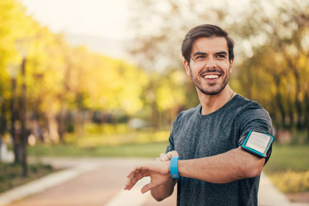 Sportsman looking at his smart watch