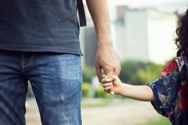 istock Father holding little girl's hand 808070188