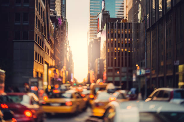 Crowded Manhattan Yellow cabs iare rushing trough the city in the sunset time. Manhattan, New York City, US. avenue photos stock pictures, royalty-free photos & images