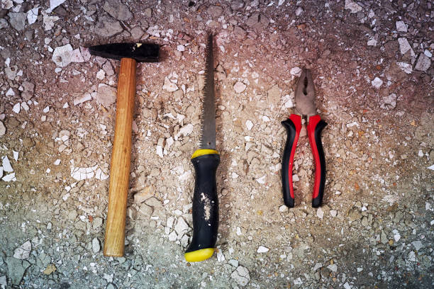 istock Hammer, saw and pliers on rubble 808078876
