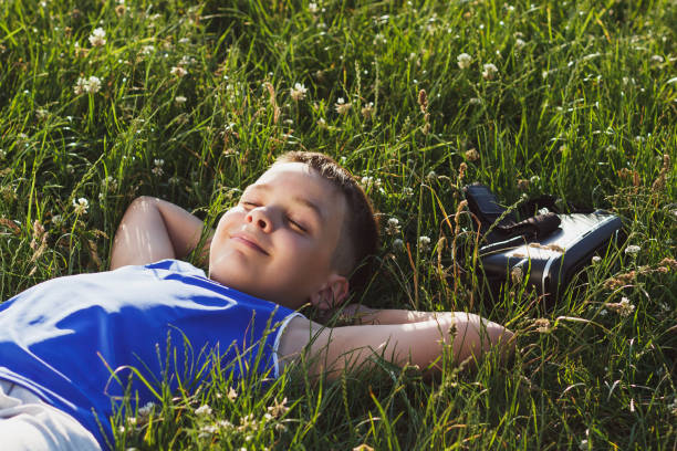 istock Boy plays game with virtual reality glasses outdoors 808084428