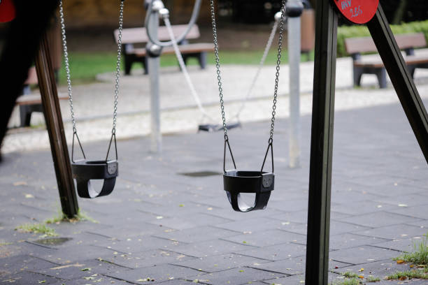 istock Swings on a children playground 808096534