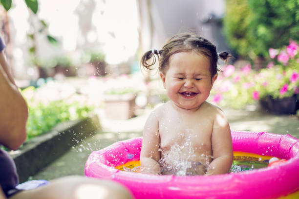 Baby splashing water with closed eyes